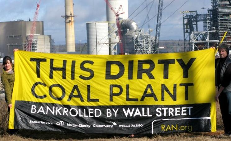 RAN activists holding a banner in front of Duke Energy's Cliffside coal plant in Cliffside, North Carolina, denouncing the banks responsible for its financing. Photo: Rainforest Action Network via Flickr (CC BY-NC).